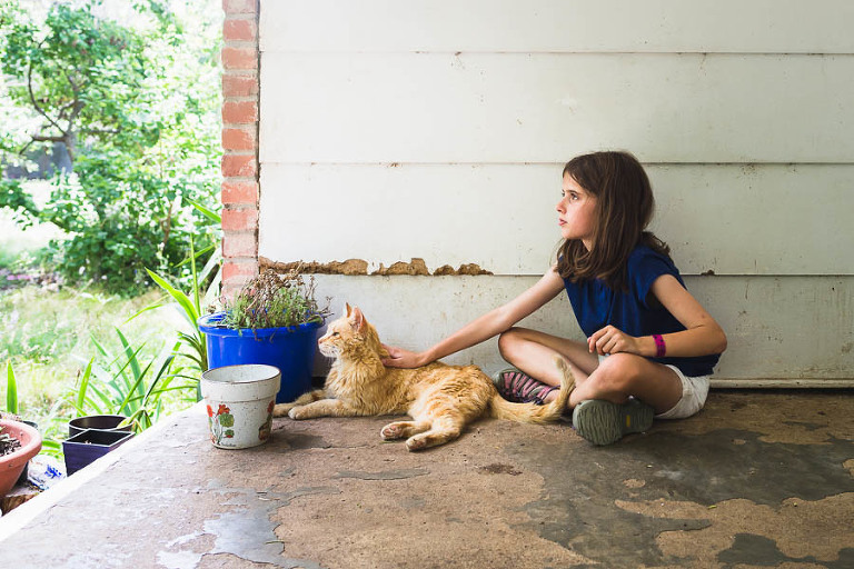 On the farm in Kansas, Megan bonded with this nameless barn cat, now known as Calvin.